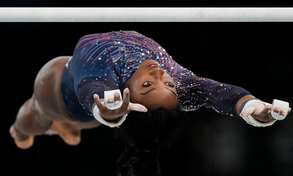 Simone Biles is on the Olympic gymnastics competition floor in front of a star-studded crowd