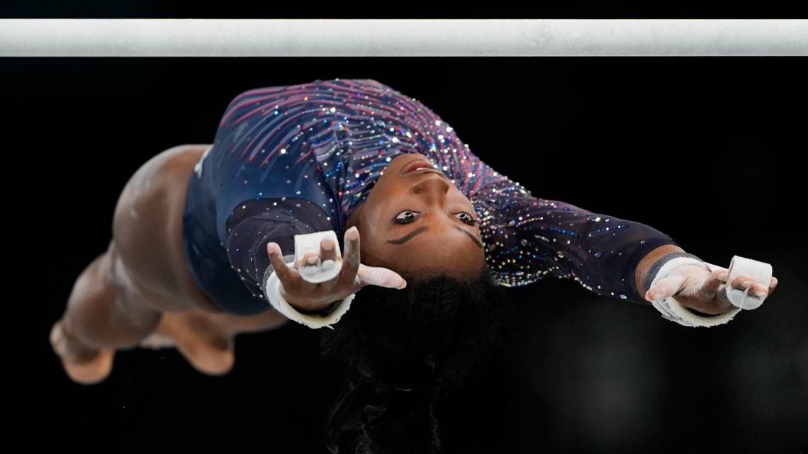 Simone Biles is on the Olympic gymnastics competition floor in front of a star-studded crowd