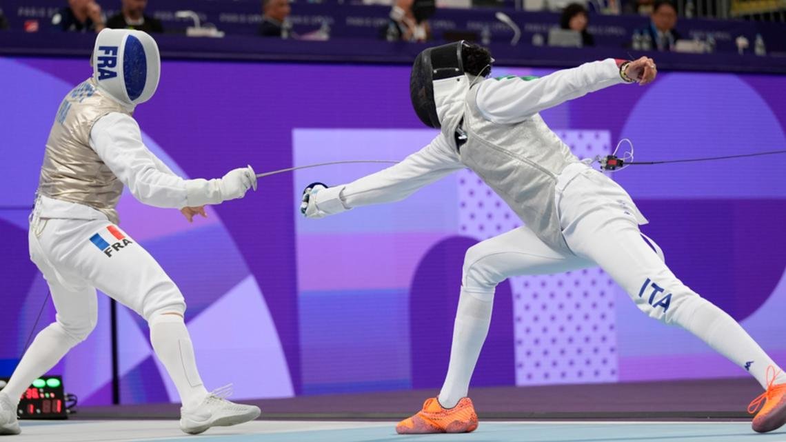 Why are fencers attached to a cable?