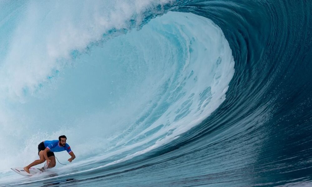 Waterproof gear and jet skis: How photographers are capturing incredible surfing shots at the Olympics