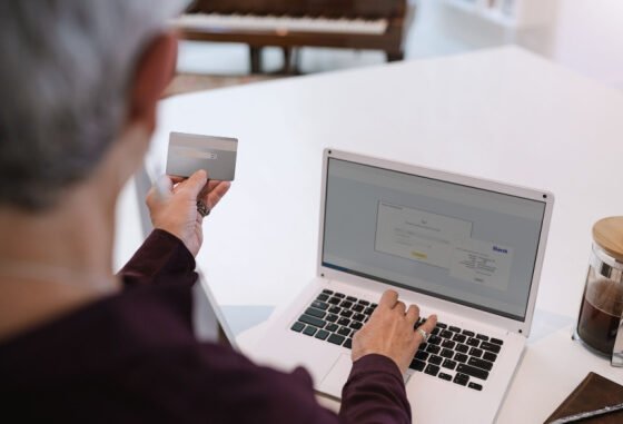 elderly woman with credit card and laptop