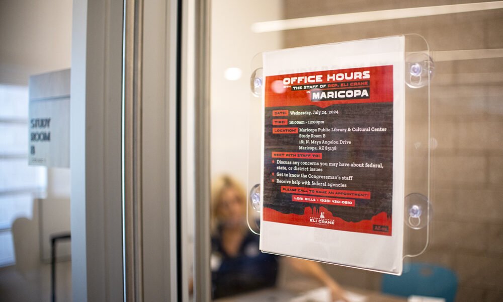 A sign advertising mobile office hours for the staff of U.S. Rep. Eli Crane is adhered to a study room door in the Maricopa Library and Cultural Center on July 24, 2024. [Monica D. Spencer]