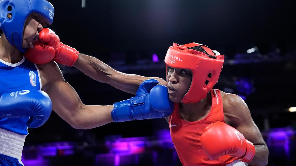 Boxer Cindy Ngamba becomes first athlete competing as a refugee to clinch an Olympic medal