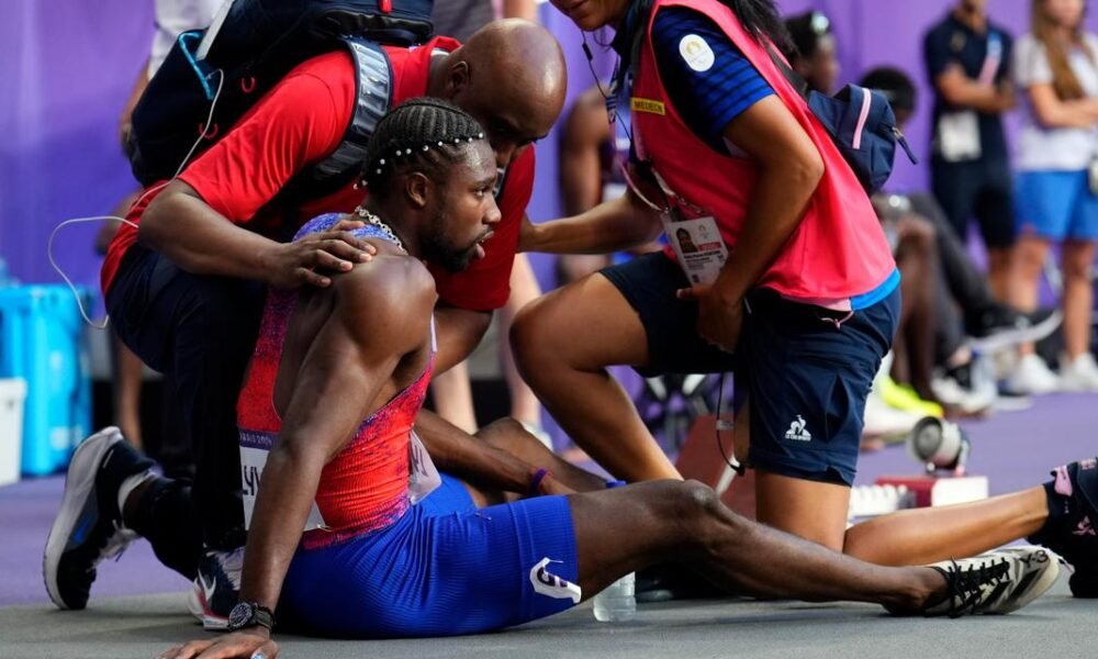 Noah Lyles tended to by medics after men's 200 final