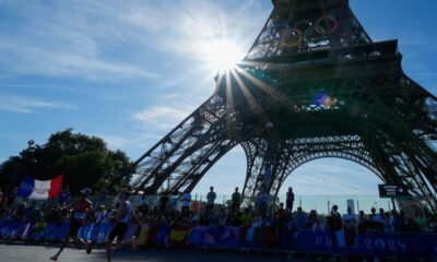 Police arrest a man climbing the Eiffel Tower, prompting an evacuation hours before closing ceremony