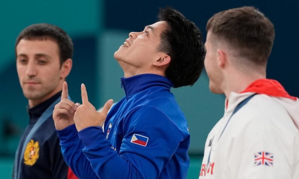 Filipino gymnast who won 2 Olympic golds in Paris gets hero's welcome and free buffets for life