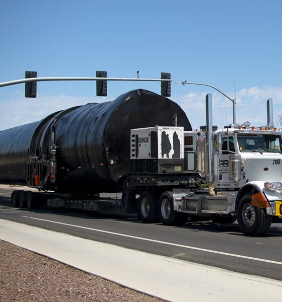 A semi-truck carrying an oversized load drives through the intersection of John Wayne Parkway and Hathaway Avenue on Aug. 29, 2024. [Monica D. Spencer]