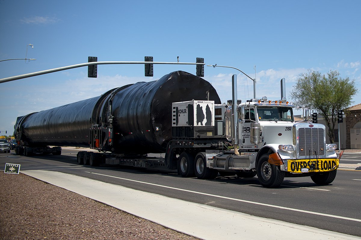 A semi-truck carrying an oversized load drives through the intersection of John Wayne Parkway and Hathaway Avenue on Aug. 29, 2024. [Monica D. Spencer]