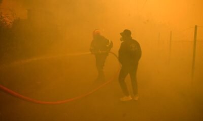 Hundreds of firefighters battle a major wildfire raging out of control on fringes of Greek capital