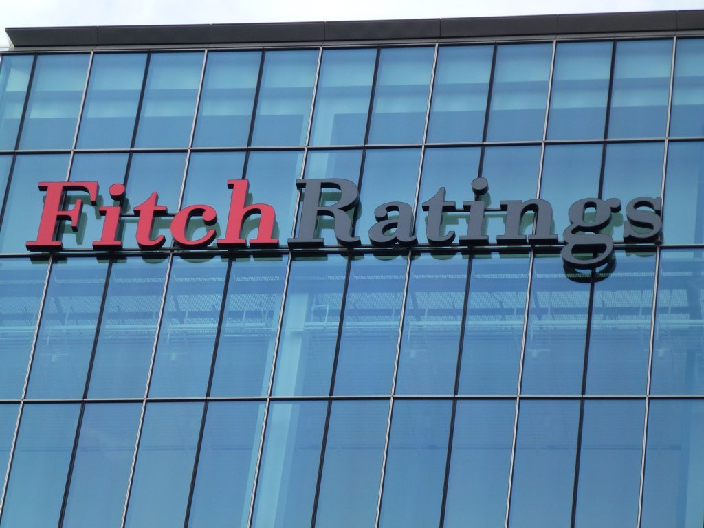 A sign for Fitch Ratings sits on the side of a building in 2012. [Gideon Benari/Flickr]