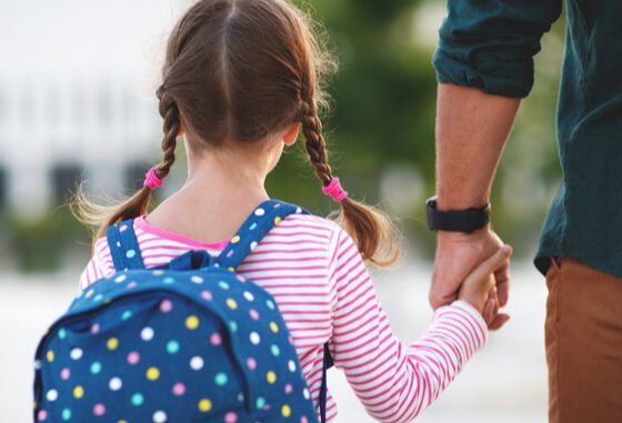 parent and child with backpack