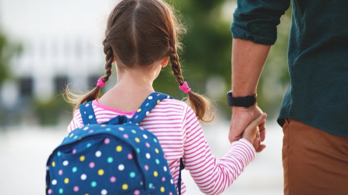 parent and child with backpack