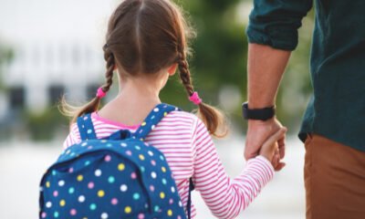 parent and child with backpack