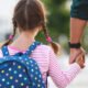 parent and child with backpack