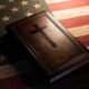 Bible with cross on American flag