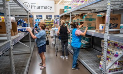 Shoppers and a store employee look through the limited toilet paper supply inside Walmart on Oct. 3, 2024. [Bryan Mordt]