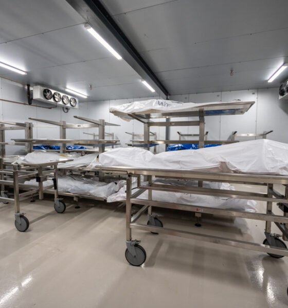 Remains in body bags lay on examination tables inside a walk-in cooler at the Pinal County Medical Examiner's Office in Florence on Aug. 4, 2023. [Bryan Mordt]