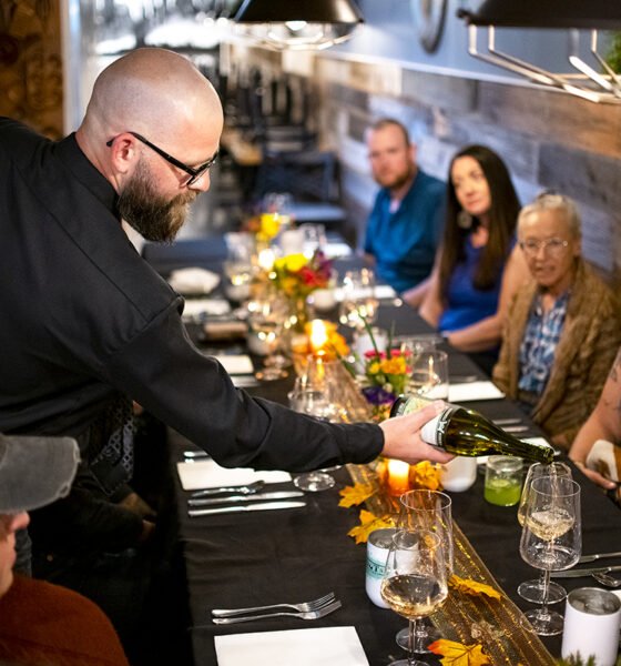 Ryan Hanners pours wine for a guest at Roots Eatery's inaugural pop-up dinner on Oct. 28, 2024. The upscale dining experience included a wine pairing with each meal from Florence's Windmill Wineries. [Monica D. Spencer]