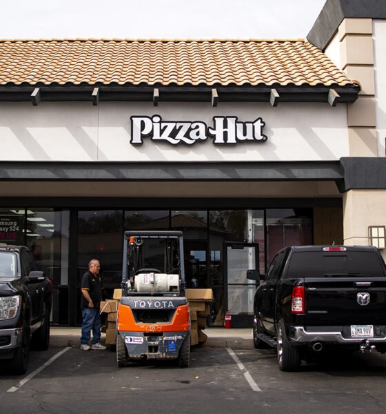 A contractor stands outside Pizza Hut's new location, a suite just between Say Sushi and T-Mobile on John Wayne Parkway, on Nov. 27, 2024. [Monica D. Spencer]