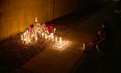 Two teens crouch in front of a memorial set up for Esteban Valenzuela, 16, near Dancer Lane and Dirk Street in Maricopa, Ariz. on Nov. 25, 2024. [Monica D. Spencer]