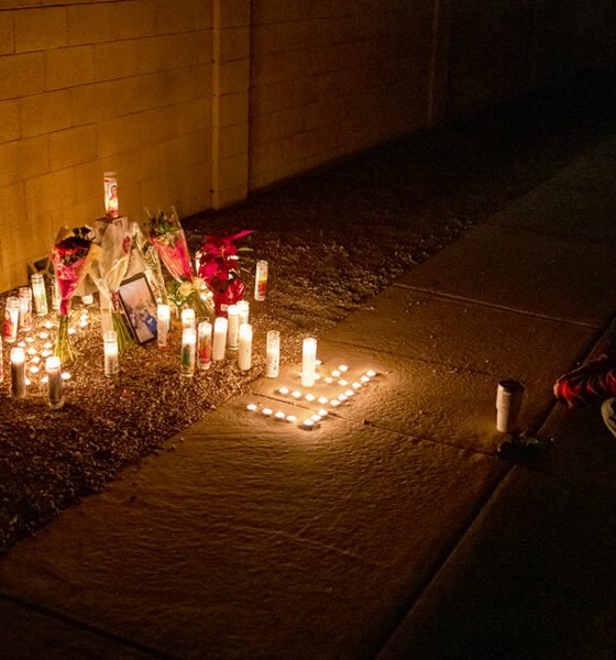 Two teens crouch in front of a memorial set up for Esteban Valenzuela, 16, near Dancer Lane and Dirk Street in Maricopa, Ariz. on Nov. 25, 2024. [Monica D. Spencer]