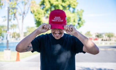 A man shows off a red hat reading "make fishing great again" outside a polling station in Maricopa on Nov. 5, 2024. [Bryan Mordt]