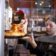 Barro's Pizza employee Madison Cross dishes a slice of pizza for the lunch crowd at the pizzeria on 44600 W. Smith Enke Road on Dec. 27, 2024. [Monica D. Spencer]