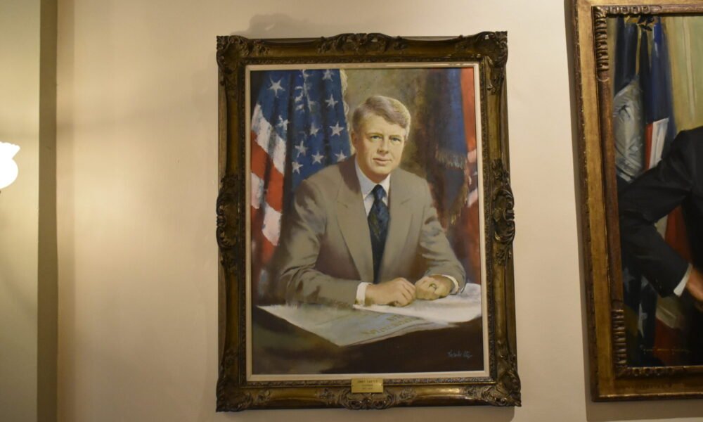 A portrait of former President Jimmy Carter hangs in the Georgia Capitol. Carter, a governor of Georgia from 1971 to 1975, died Sunday. Phot by Ross Williams