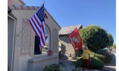 American and Marine flags on home