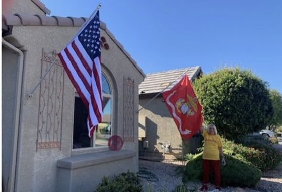 American and Marine flags on home