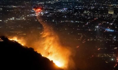 Firefighters battle to control devastating Los Angeles wildfires as ferocious winds calm somewhat