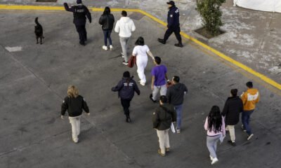 In this aerial view, Mexican immigration officials and police escort deportees after they were sent back into Mexico on Jan. 22, 2025, as seen from Nogales, Arizona. U.S. President Donald Trump signed executive orders on his first day in office declaring a state of emergency at the U.S. southern border, halting asylum claims and launching a campaign of mass deportations. (Photo by John Moore/Getty Images)