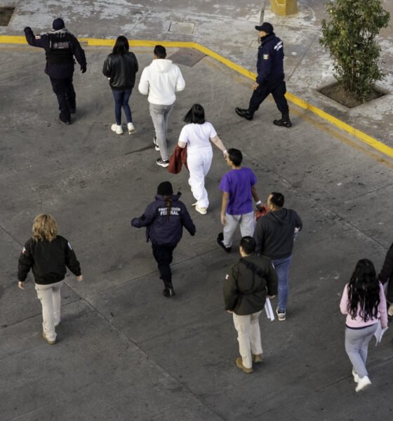 In this aerial view, Mexican immigration officials and police escort deportees after they were sent back into Mexico on Jan. 22, 2025, as seen from Nogales, Arizona. U.S. President Donald Trump signed executive orders on his first day in office declaring a state of emergency at the U.S. southern border, halting asylum claims and launching a campaign of mass deportations. (Photo by John Moore/Getty Images)