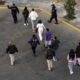 In this aerial view, Mexican immigration officials and police escort deportees after they were sent back into Mexico on Jan. 22, 2025, as seen from Nogales, Arizona. U.S. President Donald Trump signed executive orders on his first day in office declaring a state of emergency at the U.S. southern border, halting asylum claims and launching a campaign of mass deportations. (Photo by John Moore/Getty Images)