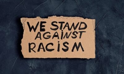 "we stand against racism" sign