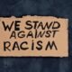 "we stand against racism" sign