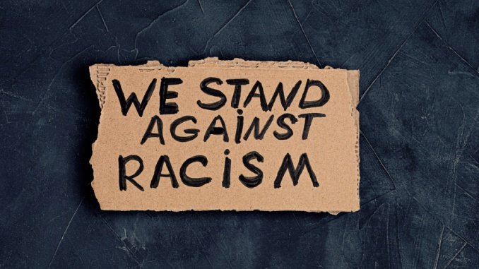 "we stand against racism" sign