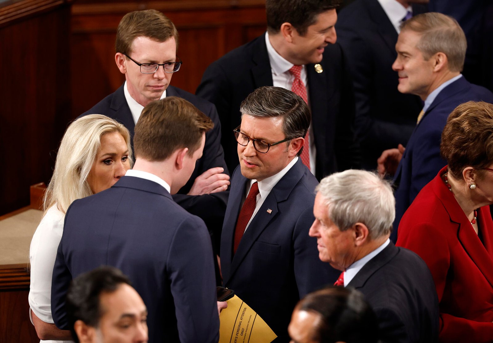 U.S. Rep. Mike Johnson, R-La., center, and Rep. Marjorie Tayler Greene, R-Ga., left, talk with fellow representatives as they arrive for the first day of the 119th Congress in the House Chamber of the U.S. Capitol Building on Jan. 3, 2025 in Washington, D.C.  (Photo by Chip Somodevilla/Getty Images)