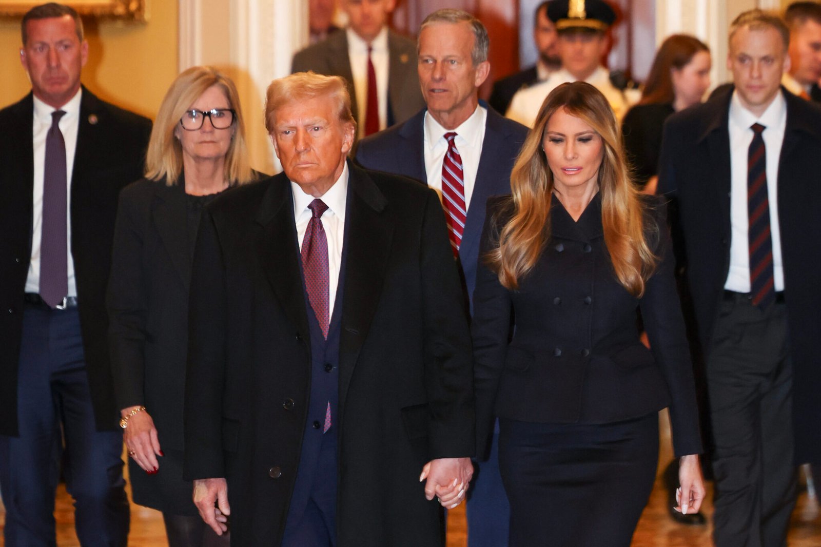 President-elect Donald Trump and wife Melania Trump arrive at the U.S. Capitol on Jan. 8, 2025, ahead of Senate Majority Leader John Thune, center. Trump met with Senate Republicans Wednesday evening. (Photo by Tasos Katopodis/Getty Images)