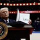 President Donald Trump holds up an executive order after signing it during an indoor inauguration parade at Capital One Arena on Jan. 20, 2025, in Washington, D.C. (Photo by Anna Moneymaker/Getty Images)