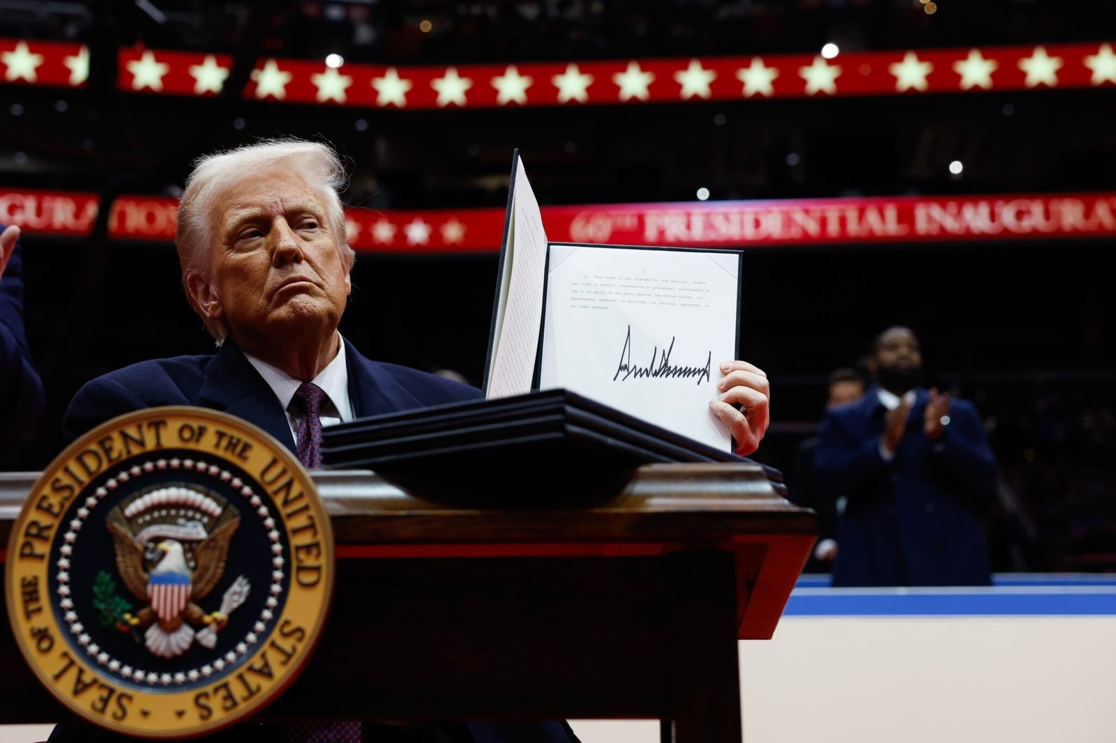 President Donald Trump holds up an executive order after signing it during an indoor inauguration parade at Capital One Arena on Jan. 20, 2025, in Washington, D.C. (Photo by Anna Moneymaker/Getty Images)