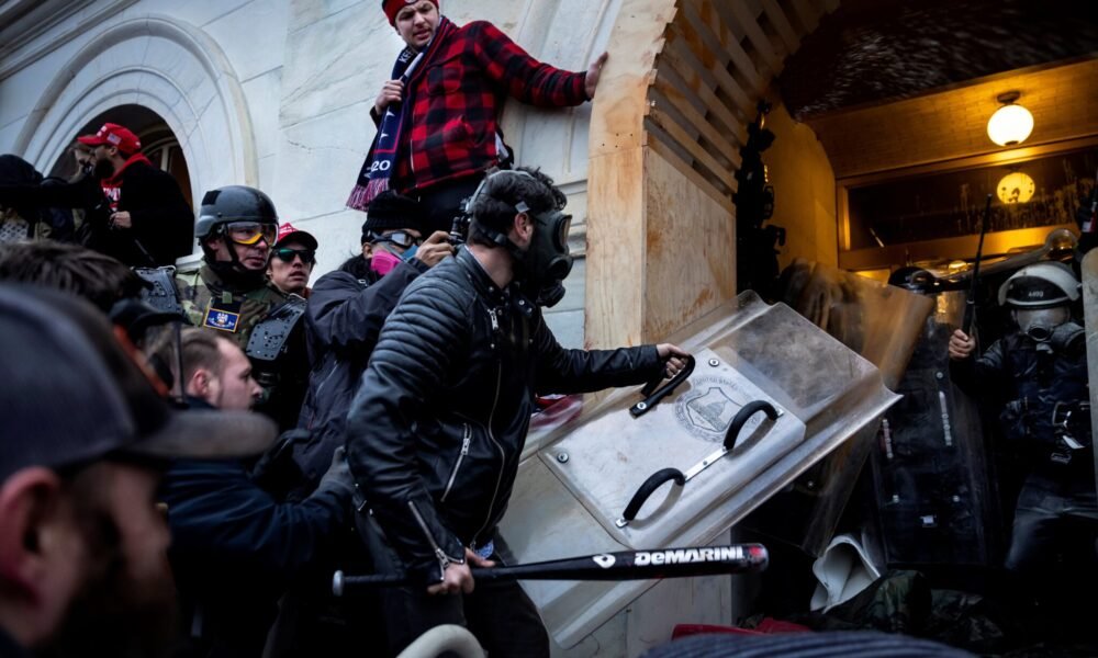 Donald Trump supporters clash with police and security forces as they storm the U.S. Capitol on Jan. 6, 2021 in Washington, D.C. (Photo by Brent Stirton/Getty Images)