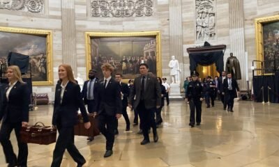 U.S. Senate pages carrying the Electoral College certificates in wooden ballot boxes walk through the Capitol rotunda on their way to the U.S. House chamber on Monday, Jan. 6, 2025. (Photo by Jennifer Shutt/States Newsroom)