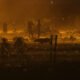 Migrants wait throughout the night May 10, 2023, in a dust storm at Gate 42, on land between the Rio Grande and the border wall. (Photo by Corrie Boudreaux for Source New Mexico)