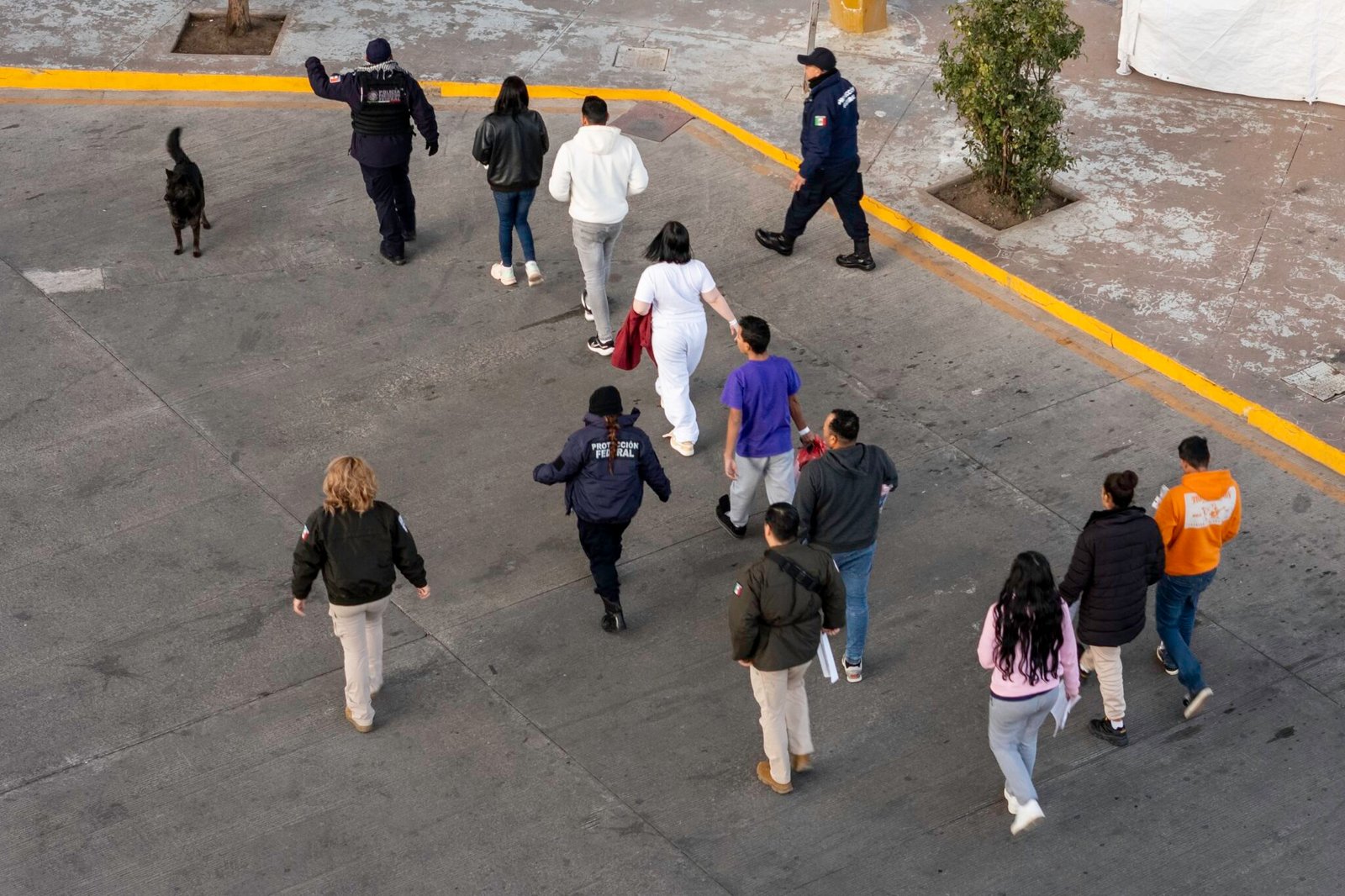 In this aerial view, Mexican immigration officials and police escort deportees after they were sent back into Mexico on Jan. 22, 2025, as seen from Nogales, Arizona.  (Photo by John Moore/Getty Images)