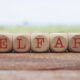 welfare spelled out in wooden blocks