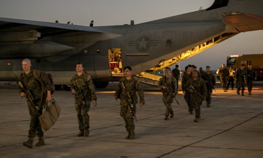 U.S. Marines with the 1st Battalion, 6th Marine Regiment, 2d Marine Division, disembark from a C-130 Hercules at Naval Station Guantanamo Bay, Cuba, on Feb. 1, 2025. The Marines have been deployed there as the Trump administration begins flights to Guantanamo Bay to detain up to 30,000 people who lack U.S. legal status. (U.S. Navy photo by Jovi Prevot)