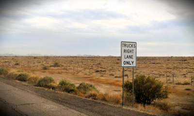 A sign reading "trucks right lane only" sits on the side of Interstate 10 in this undated photo. [Google Maps]