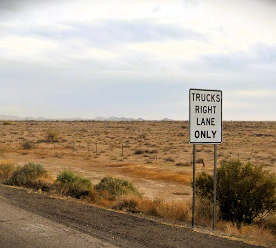 A sign reading "trucks right lane only" sits on the side of Interstate 10 in this undated photo. [Google Maps]