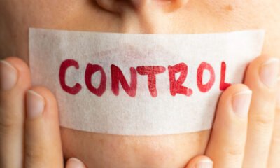 tape on woman's mouth with control written on it